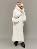 Close-up of the front of a long white hooded faux fur coat, showing the belt, buttons, and pockets.