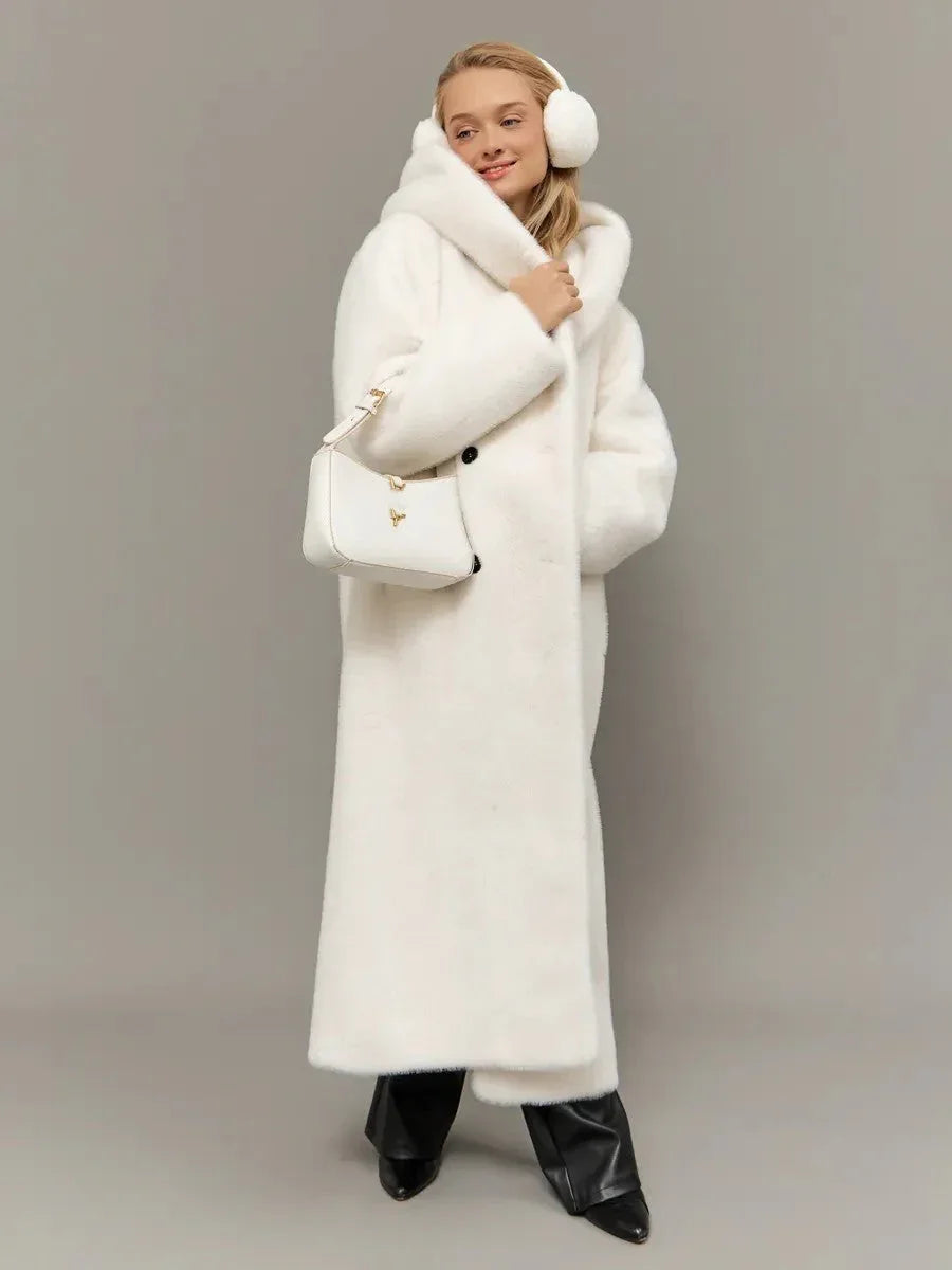 Close-up of the front of a long white hooded faux fur coat, showing the belt, buttons, and pockets.