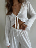 Front view detail of the white sheer knit loungewear set, with a focus on the tie-front detail and fabric texture.
