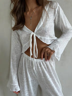 Front view detail of the white sheer knit loungewear set, with a focus on the tie-front detail and fabric texture.