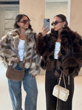 Two women wearing patterned faux fur jackets