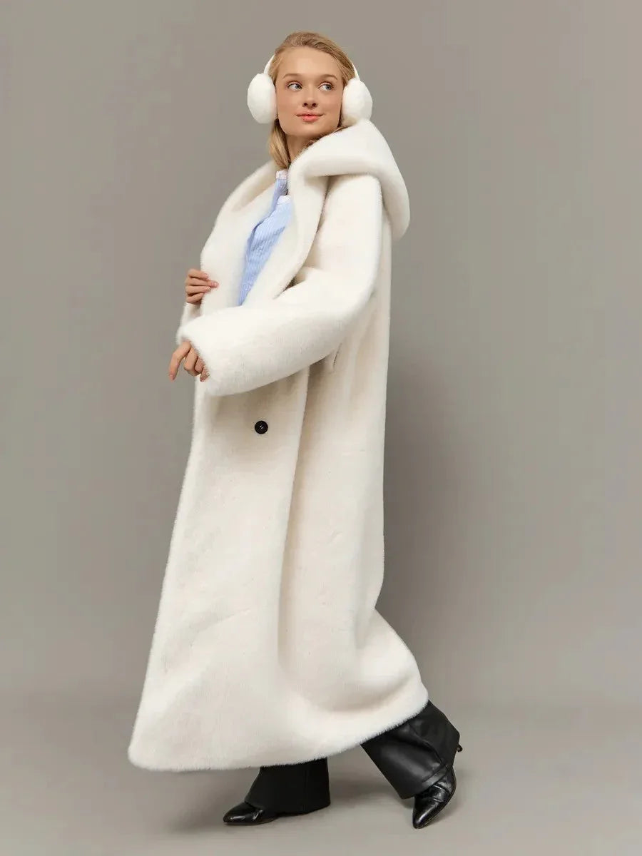 Woman wearing a long white hooded faux fur coat, showing the coat's front with a blue shirt underneath.