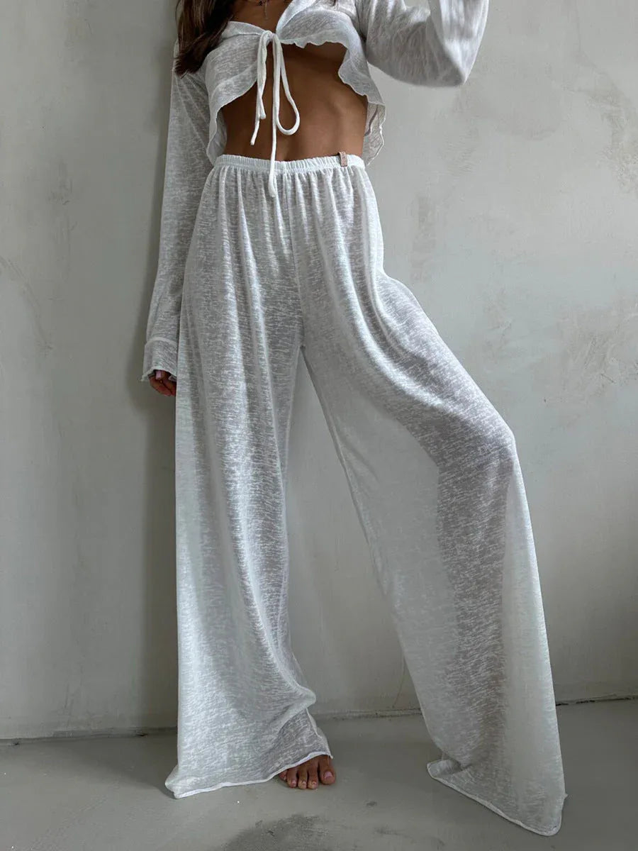 Close-up of the white sheer knit set, highlighting the V-neck tie-front top and drawstring waist pants.