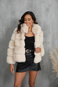 Woman wearing a cream faux fur jacket