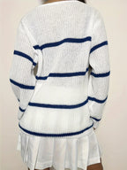 Back view of a woman in a white knit sweater with navy blue horizontal stripes.