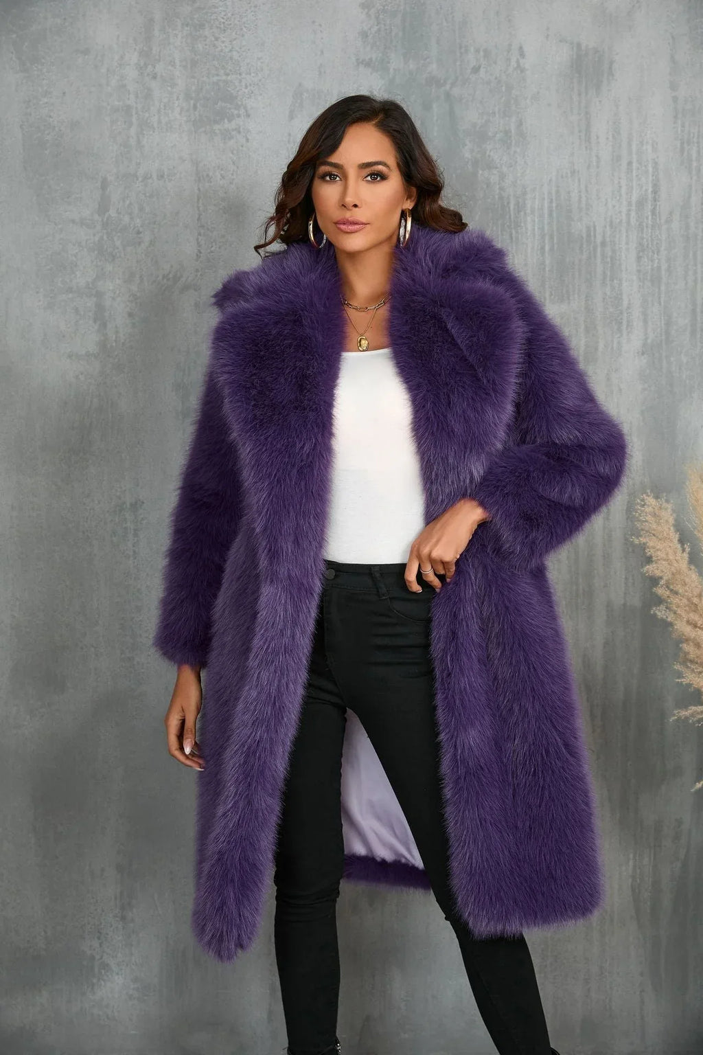 Woman wearing a long purple faux fur coat with a notched lapel collar.