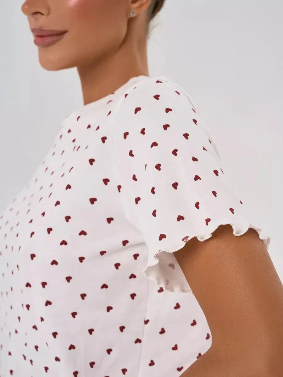Close-up of the sleeve of the pajama top showing the heart print and ruffled edge.