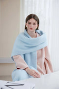Woman in a pink coat with a light blue brushed mohair blend scarf around her neck.