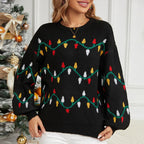 Model styled in a black festive sweater with a Christmas tree backdrop