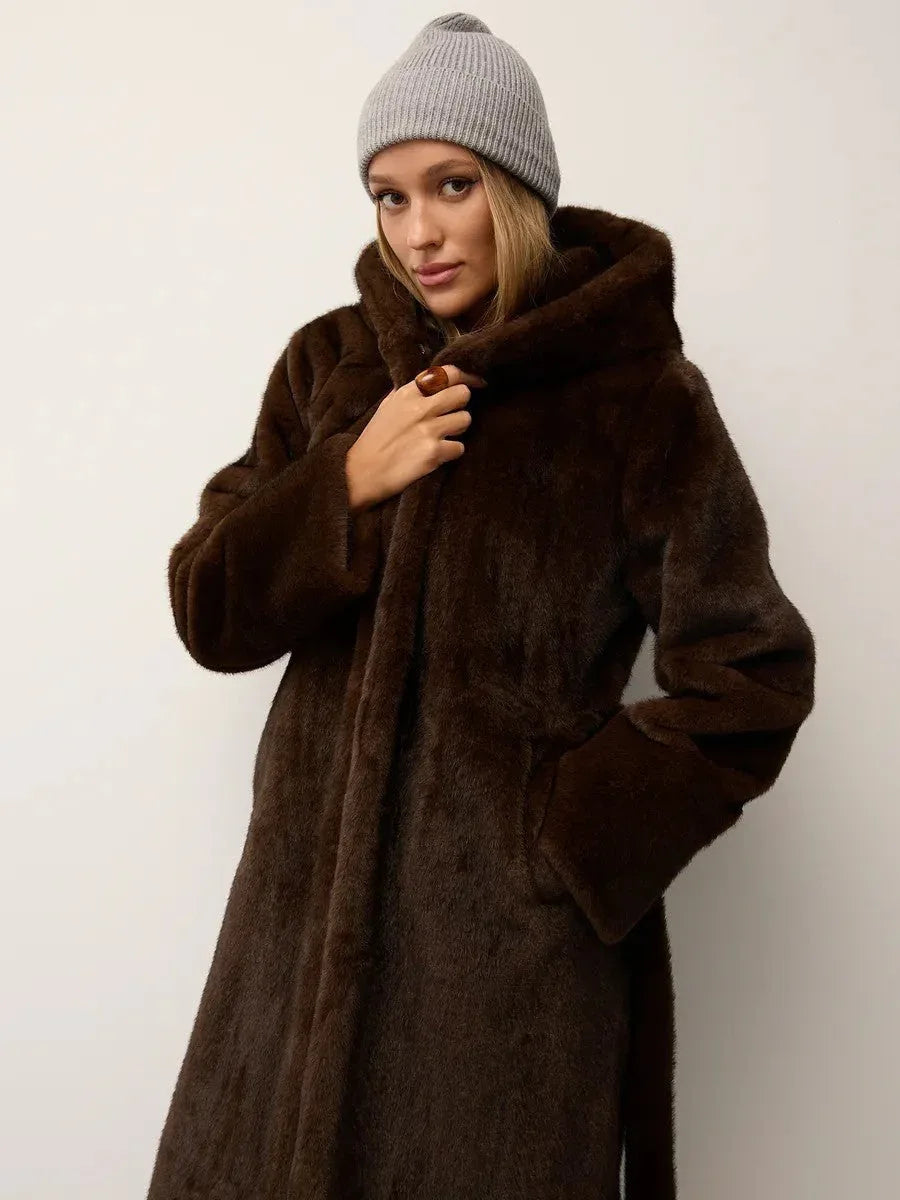 Woman wearing a long brown faux fur coat with a hood and a grey beanie. Main image