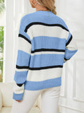 Back view of a woman in a blue, white, and black striped knit sweater.