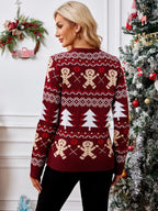 Back view of a woman wearing a burgundy knit sweater with gingerbread man and Christmas tree pattern.