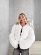 Front view of a woman modeling a white faux fur cropped jacket.