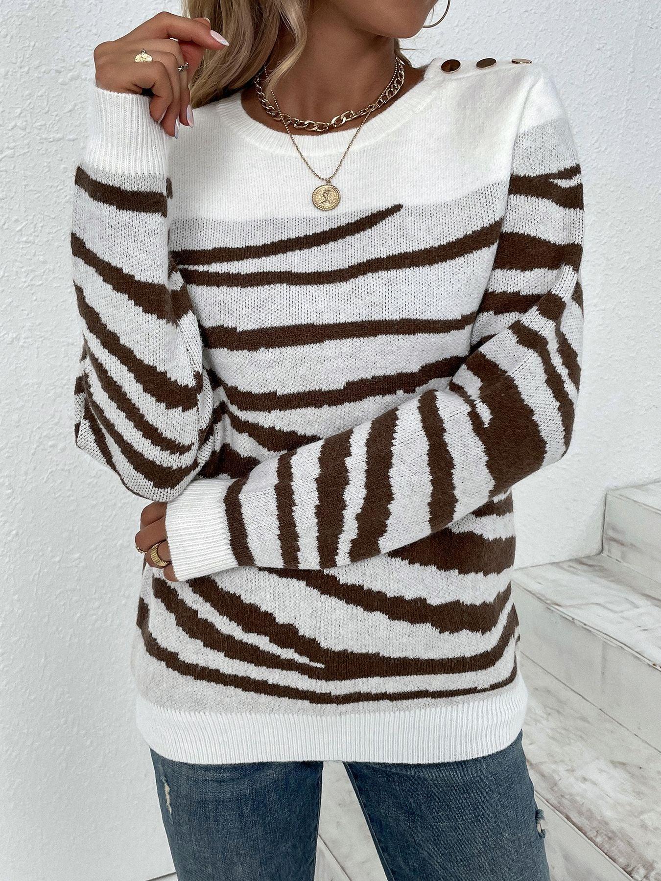 Model posing in a zebra print crew neck sweater and blue jeans