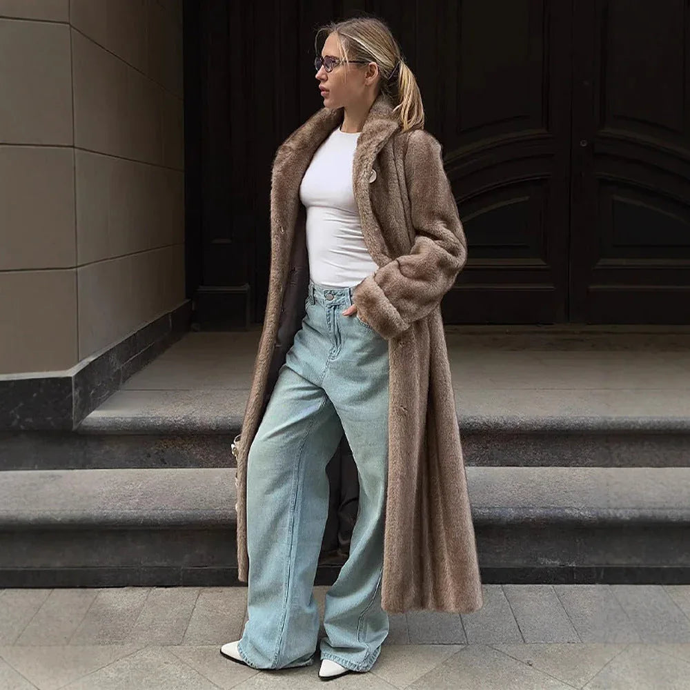 Woman wearing a long brown faux fur coat, white t-shirt, and light blue wide-leg jeans. Main image