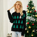 Woman wearing a black Christmas tree knit sweater with sequin accent