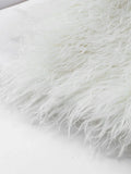 Close-up of cream shaggy faux fur texture detail
