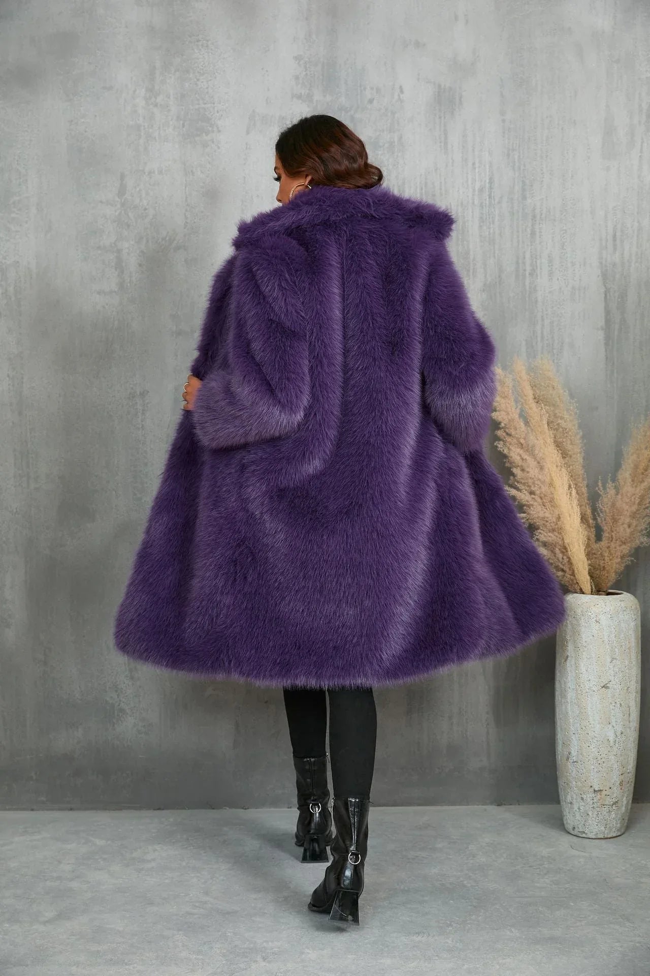 Rear view of a woman in a purple faux fur coat.