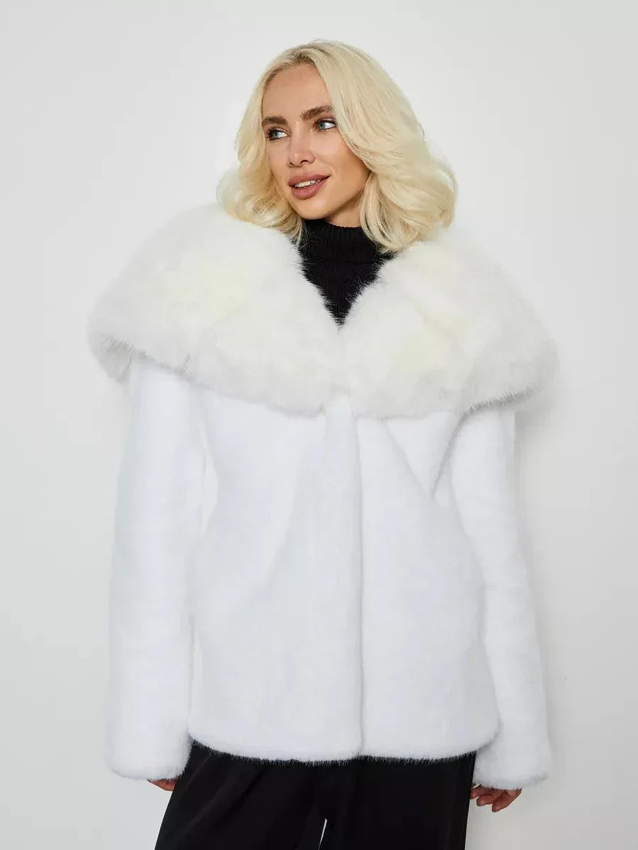 Close-up of a woman wearing a white faux fur coat with a large collar.