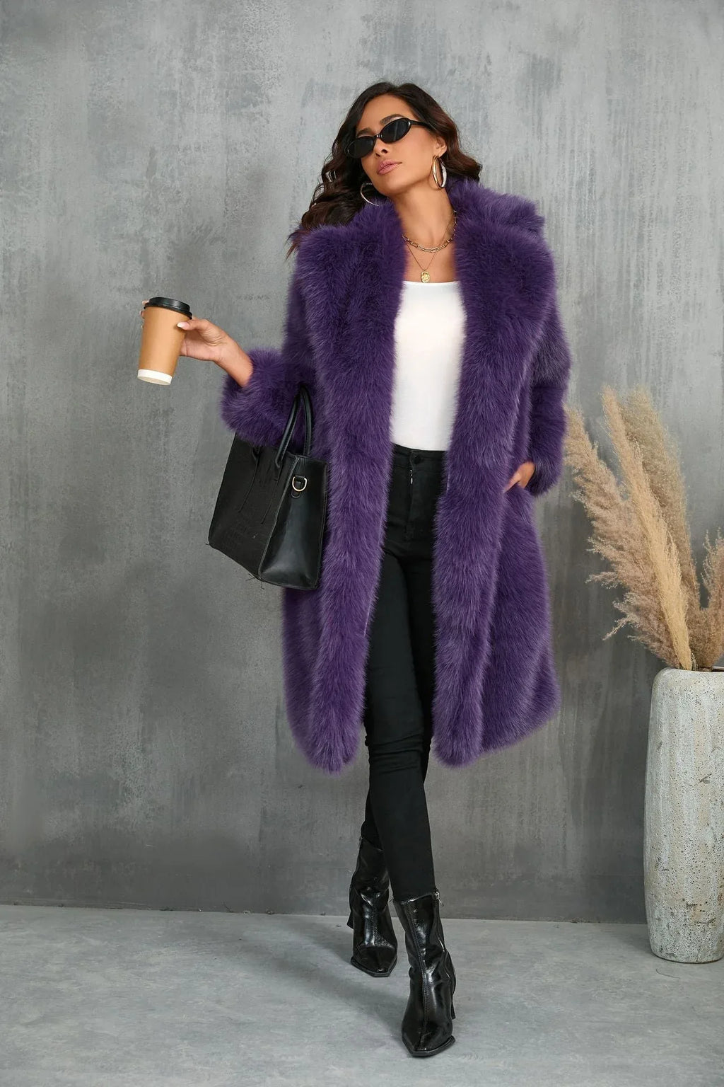 Woman in a purple faux fur coat holding a coffee cup and handbag.
