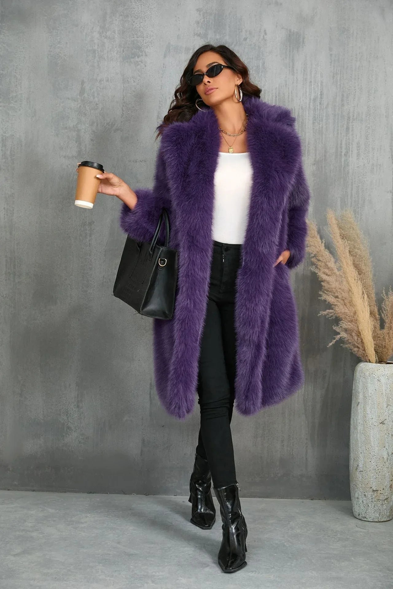Woman in a purple faux fur coat holding a coffee cup and handbag.