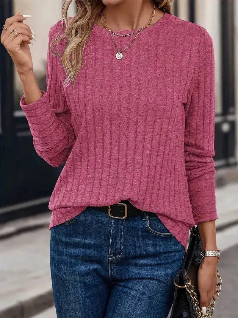 Woman wearing a pink ribbed knit crew neck long sleeve top
