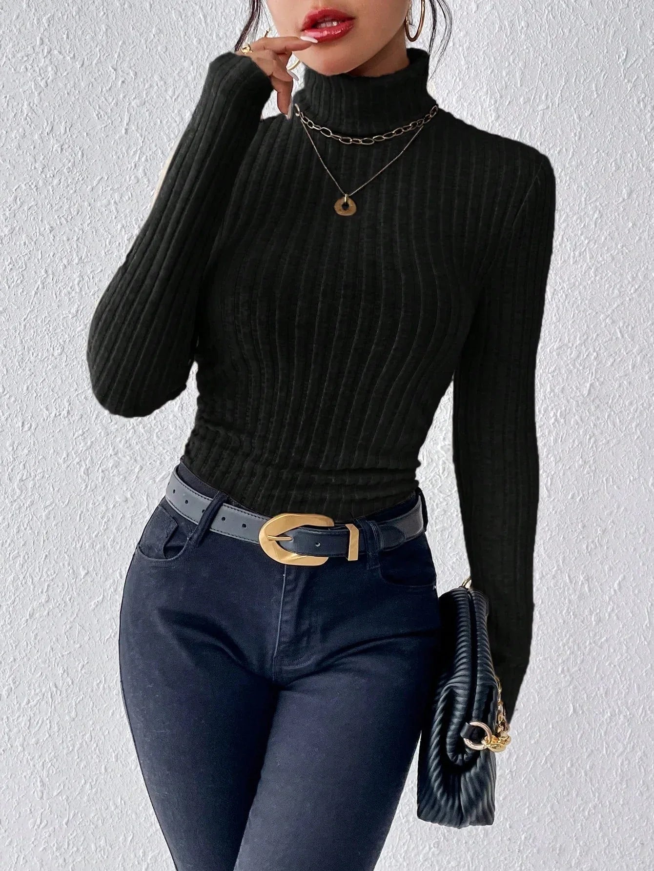 Model showcasing a black ribbed turtleneck for layering