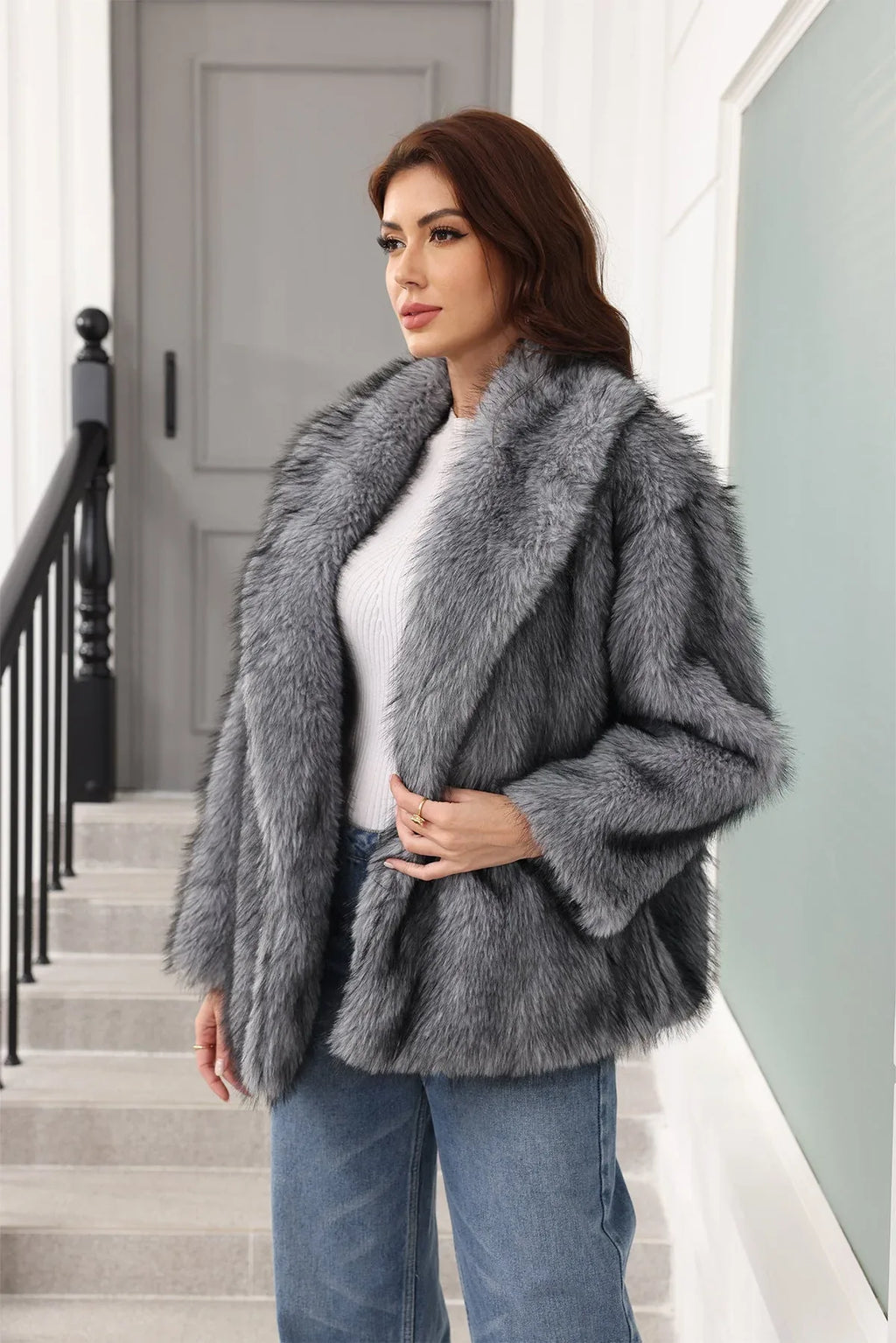 Woman in a grey faux fur jacket with a notched lapel, looking to the side.