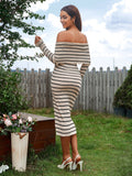 Back view of a woman in a beige and black striped off-the-shoulder midi dress with long sleeves.