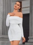 Woman posing in a white off-the-shoulder ruched mini dress with long sleeves