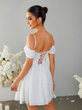 Back view of a woman in a white off-the-shoulder dress with a lace-up corset back.