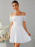 Woman wearing a white off-the-shoulder ruched bodice dress with puff sleeves and a full skirt.