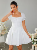 Woman smiling and adjusting her white off-the-shoulder dress with puff sleeves.
