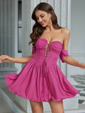 Woman wearing a fuchsia off-the-shoulder ruched bodice lace-up front chiffon dress with a flared skirt