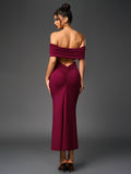 Back view of a woman in a floor-length, off-the-shoulder maroon dress showcasing ruched detailing and an open back.