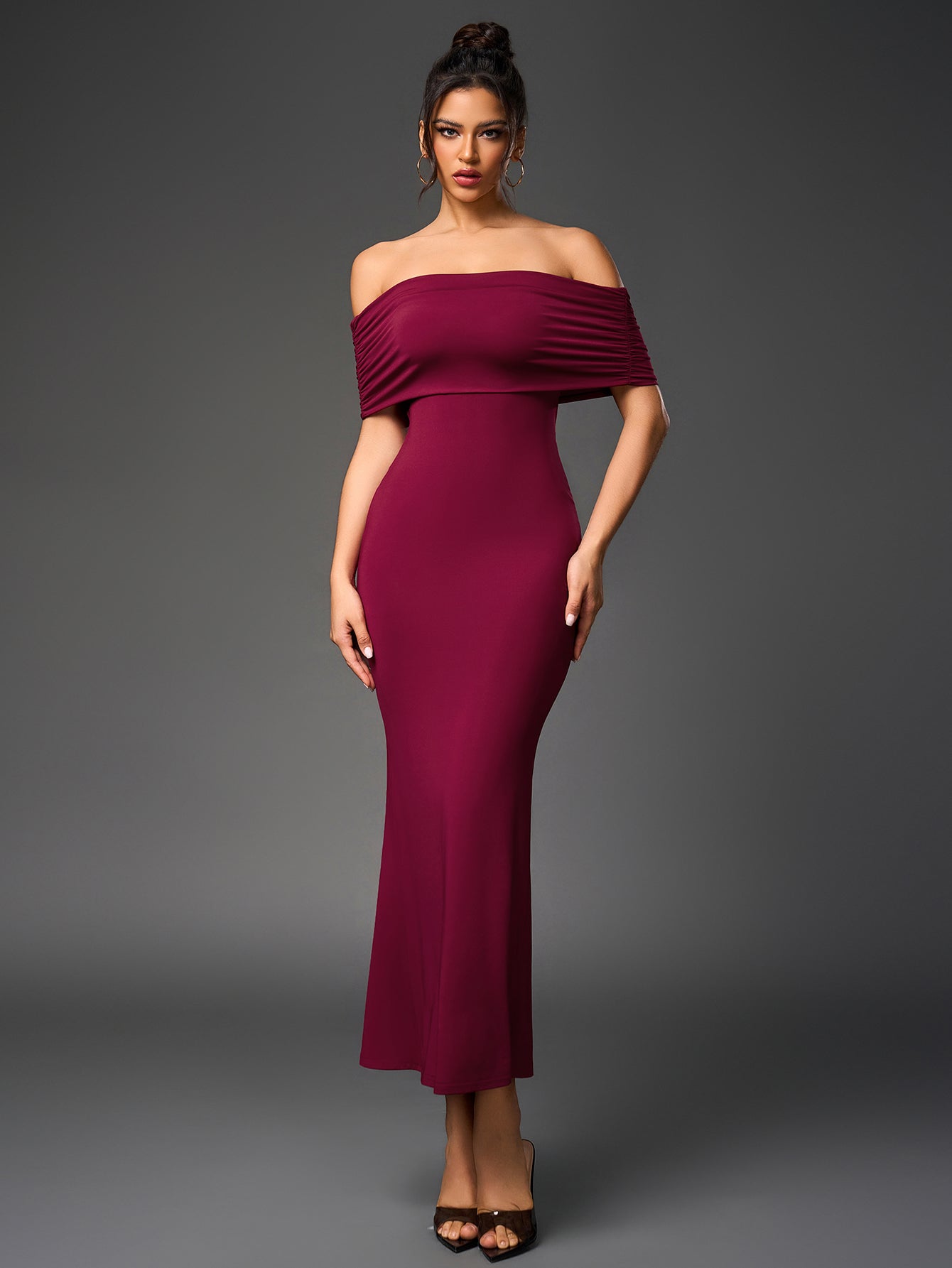 Model showcasing a sophisticated maroon formal dress with an off-the-shoulder neckline and floor-length cut.