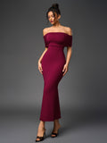 Front view of a woman modeling a fitted, off-the-shoulder maroon gown with a mermaid silhouette.