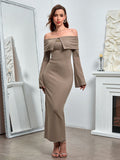 full body shot of a woman wearing a taupe off-the-shoulder knit midi dress
