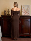 Back view of a woman in a floor-length brown dress with an off-the-shoulder neckline