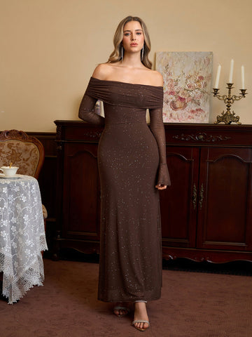 Woman wearing a long brown off-the-shoulder dress with sparkling details
