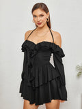 Model posing in a black off-the-shoulder dress with tiered ruffles.