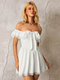 Close-up of a woman wearing a white off-the-shoulder dress with ruffled and lace trim, and a bow detail.