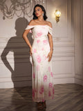 Woman with hands on hips in a white off-the-shoulder maxi dress with a pink floral print.
