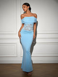 Full-length shot of a woman in a light blue off-the-shoulder trumpet gown, showcasing the ruched bodice and lace insert.