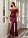 Woman wearing a floor-length burgundy off-the-shoulder dress with ruched detailing and a mermaid hem.