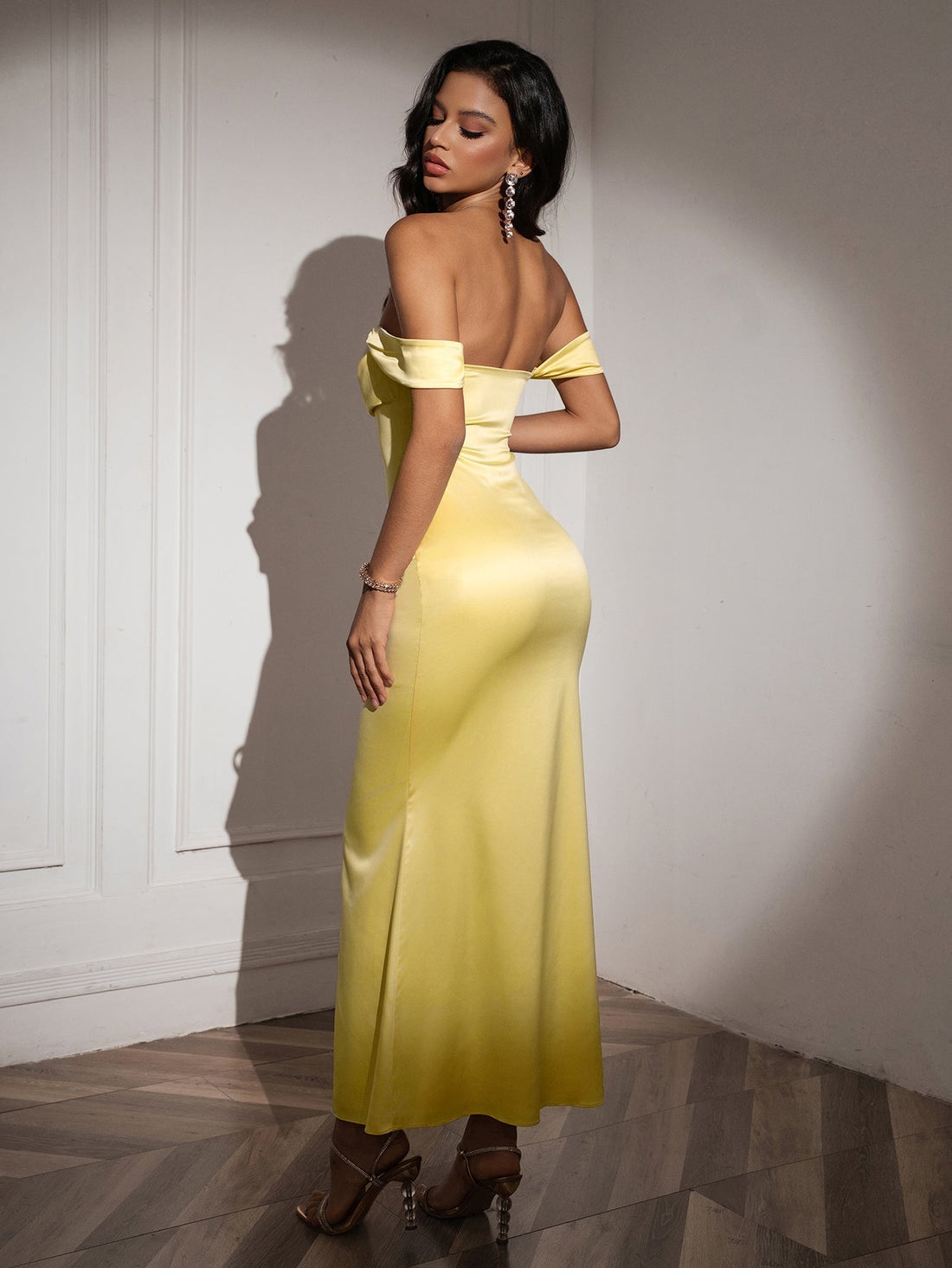Woman wearing a yellow off-the-shoulder satin mermaid gown