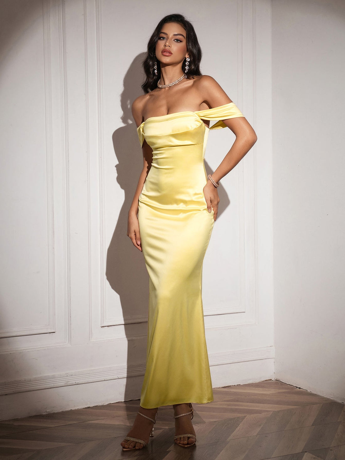 Woman wearing a yellow off-the-shoulder satin mermaid gown