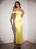 Model posing in a yellow satin floor-length dress