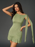Woman with hand on head wearing a lime green one-shoulder sheath dress with draped sleeve detail and ruffled hem.