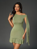 Woman posing in a lime green one-shoulder sheath dress with draped sleeve detail and ruffled hem.
